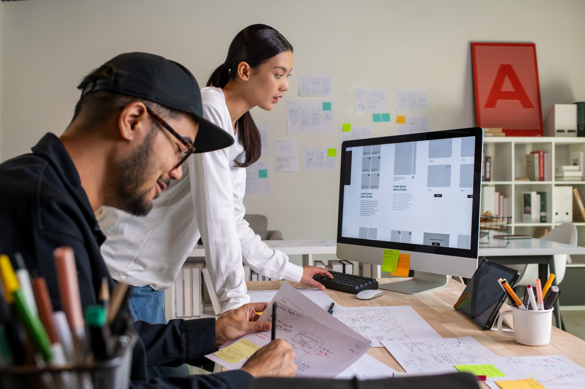 Web design professionals collaborating on website and mobile app prototypes